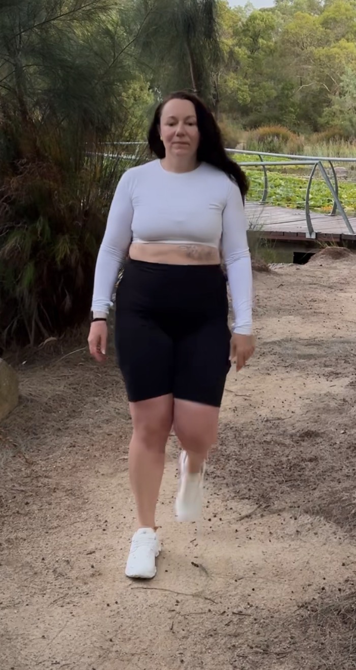 Kym before her weight loss journey, walking outdoors