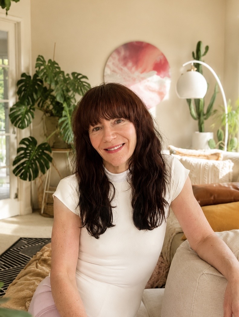 Kym smiling at home